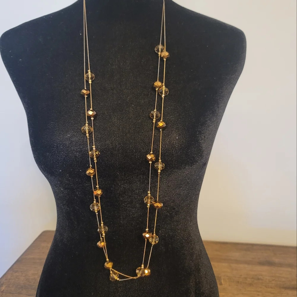 Long gold beaded necklace. V